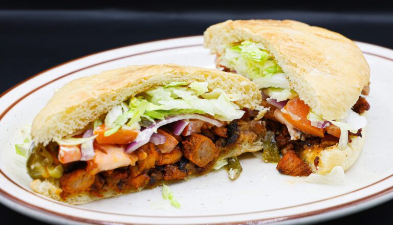 Milanesa, smoked mexican sausage, fresh and melted cheese. Topped with lettuce, tomato, onion, jalapenos and avocado served on bread then cut in half at Super Carniceria.